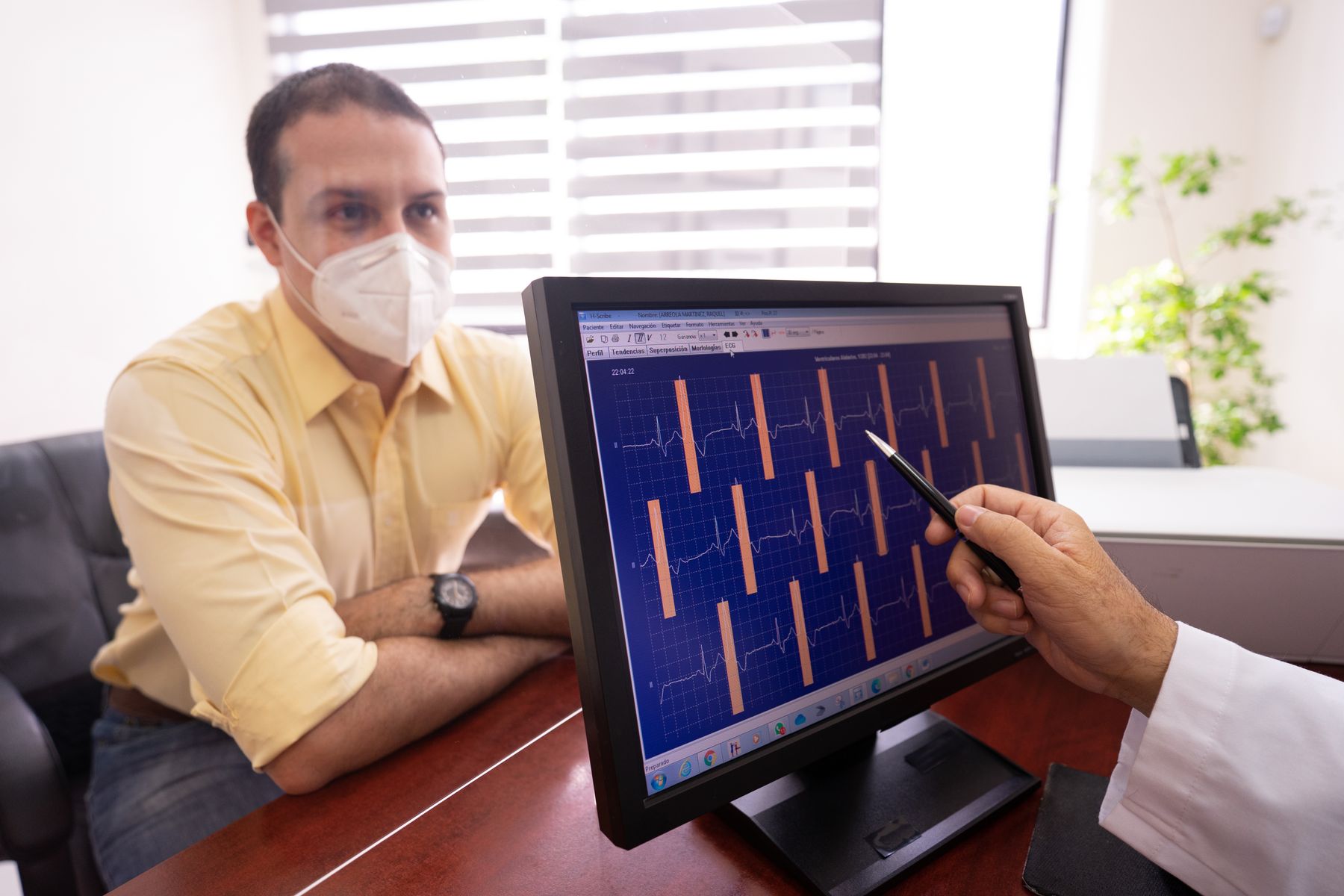 A clinician reviewing ECG results with a patient